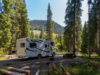 beautiful campsite mountains with rv wooden bench scaled
