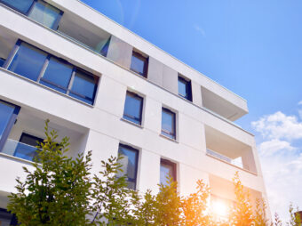 building-with-blue-sky-trees-background building with blue sky trees background scaled