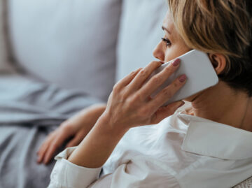 distraught woman resting sofa communicating mobile phone scaled