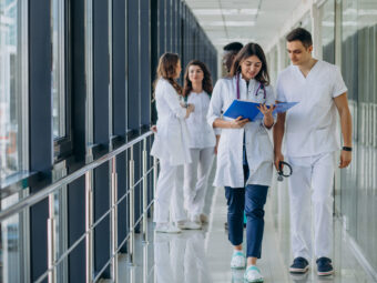team-young-specialist-doctors-standing-corridor-hospital team young specialist doctors standing corridor hospital scaled