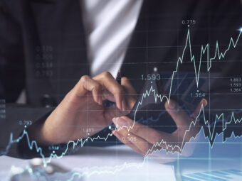 A woman financial trader in formal wear is checking the phone to sign the contract to invest money in stock market. Internet trading and wealth management concept. Forex hologram chart. woman financial trader formal wear is checking phone sign contract invest money stock market internet trading wealth management concept forex hologram chart scaled