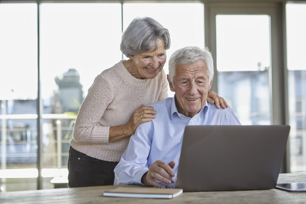 portrait of smiling senior couple using laptop 2023 11 27 05 19 33 utc